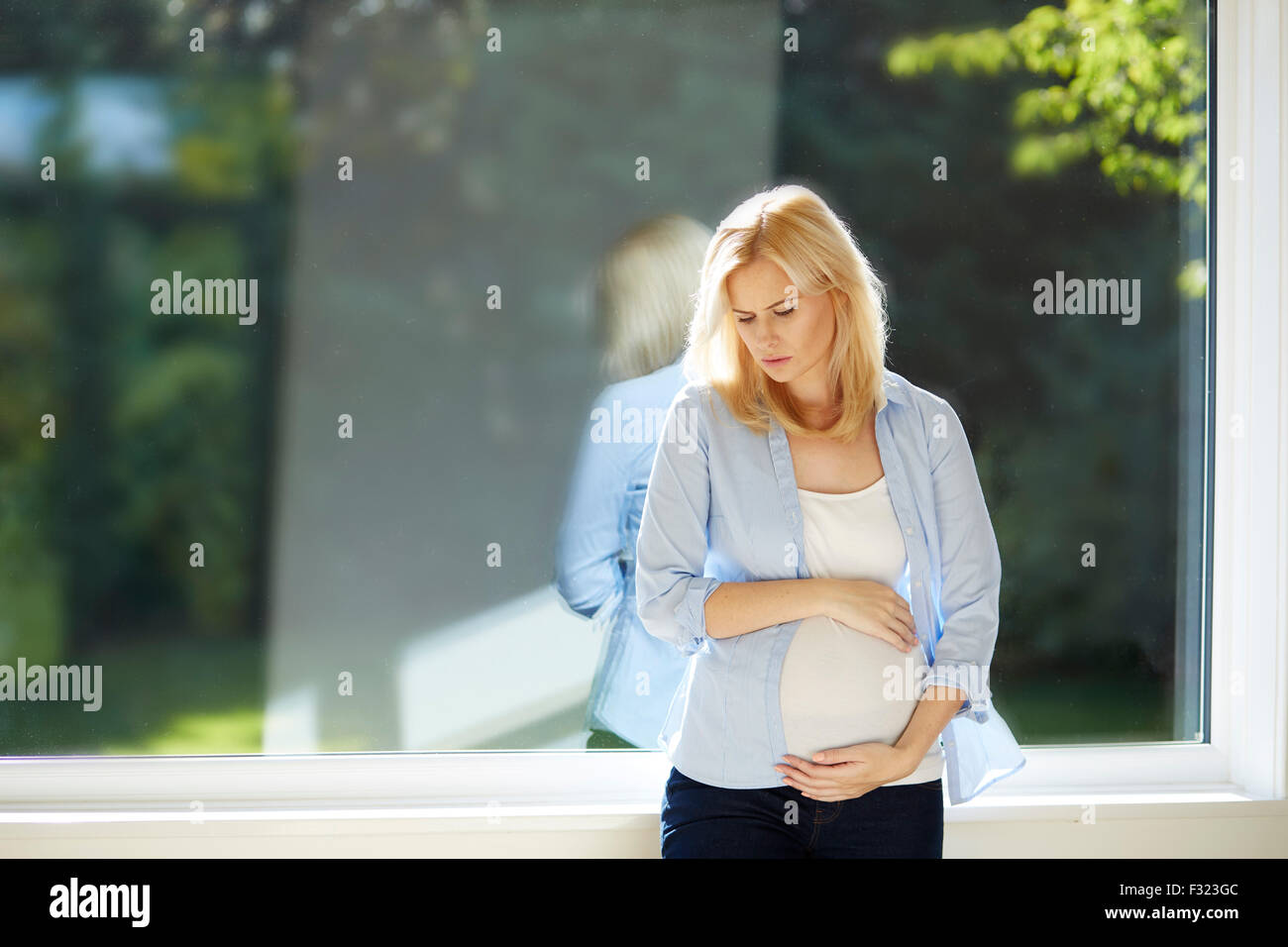 Worried pregnant woman Stock Photo