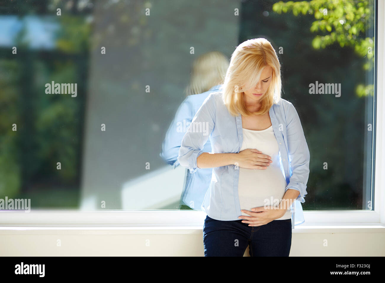 Worried pregnant woman Stock Photo