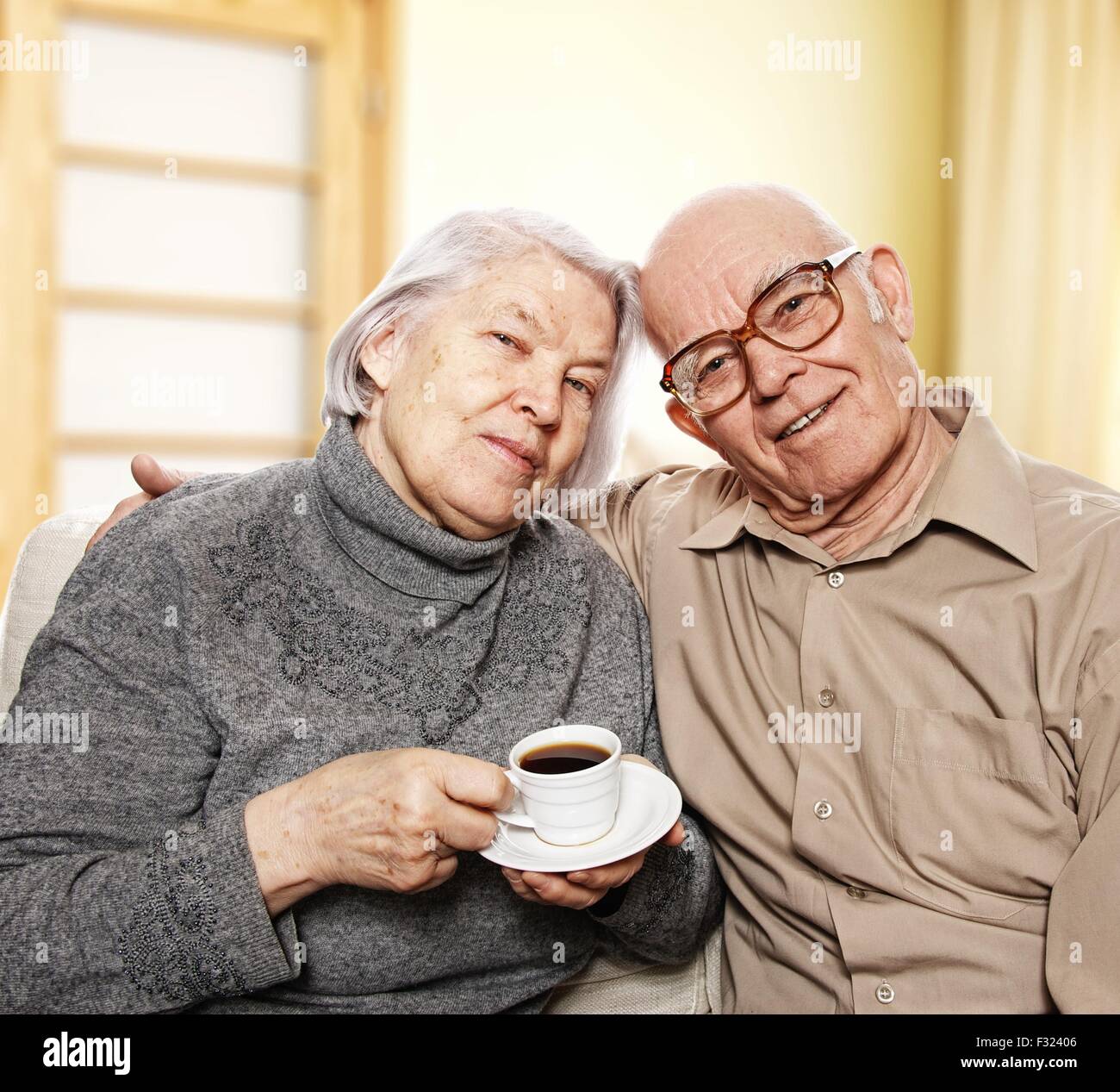 Happy senior couple drinking coffee at home Stock Photo - Alamy
