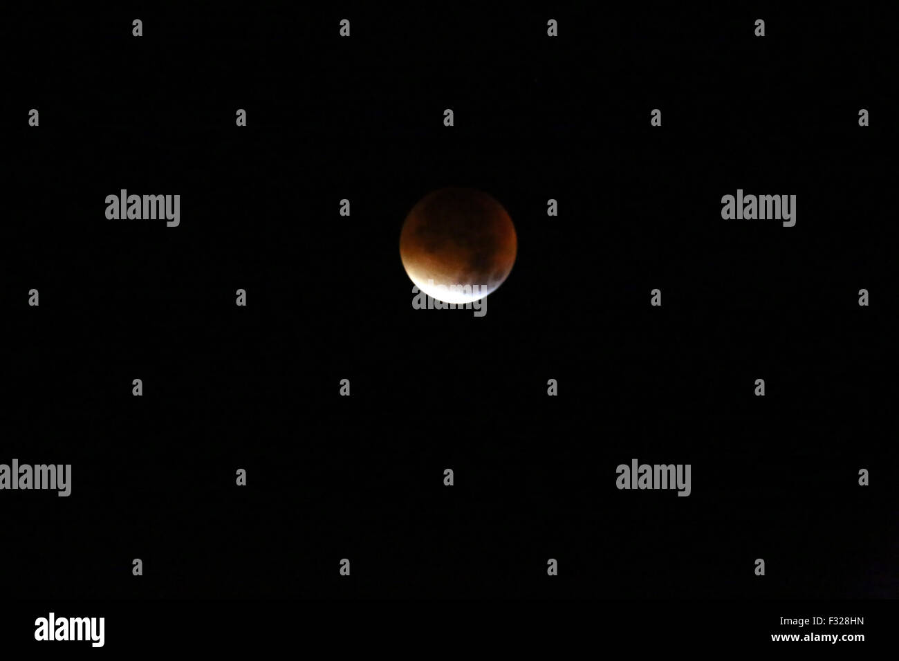 Berlin, Germany. 28th Sep, 2015. Astronomical phenomenon at Monday morning 3am as the moon appeared bigger as usual in reddish hue combined with a supermoon lunar eclipse. Credit:  Jake Ratz/Alamy Live News Stock Photo