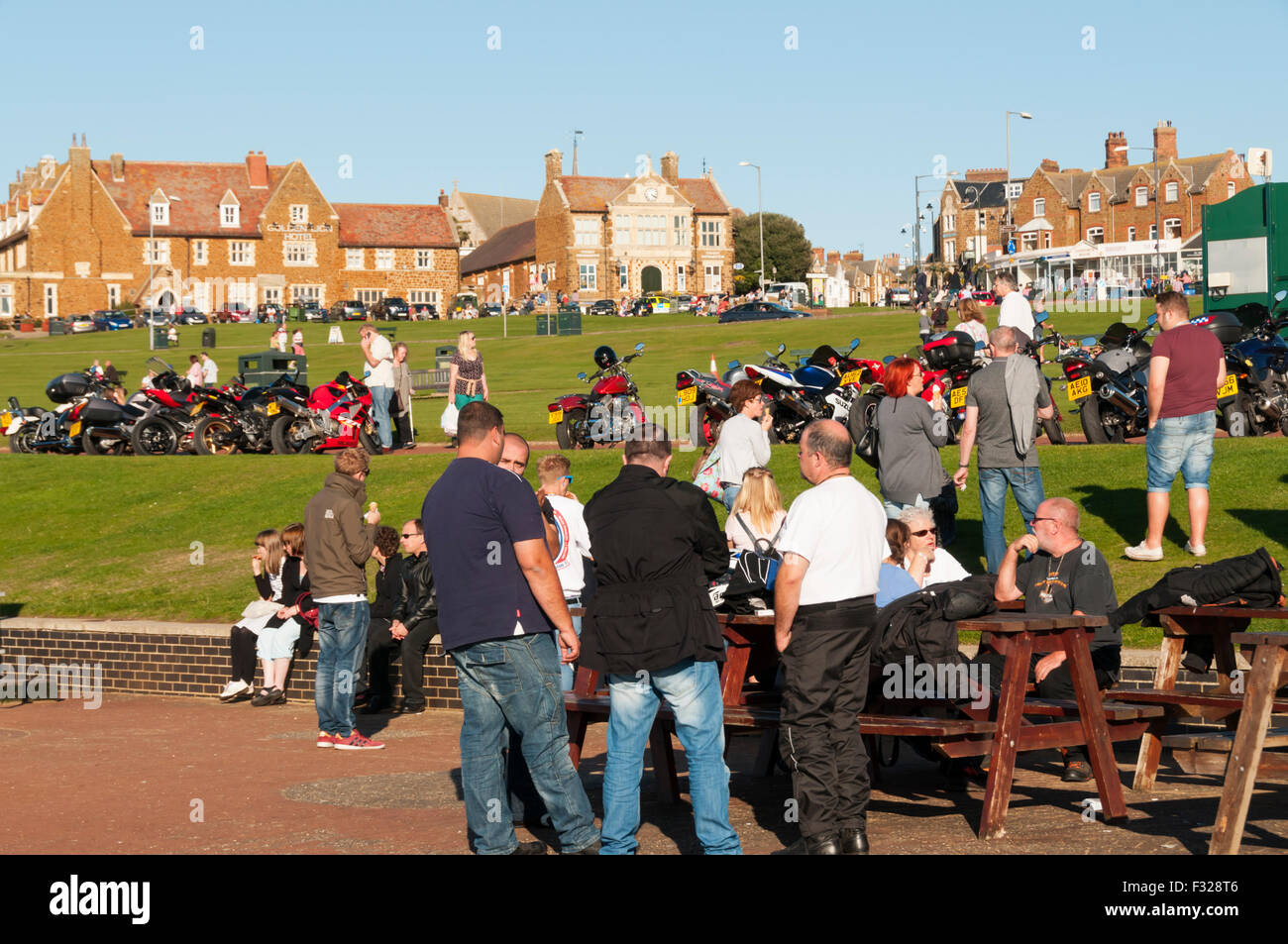 Middle aged motorcyclists meet up on The Green at Hunstanton Stock Photo