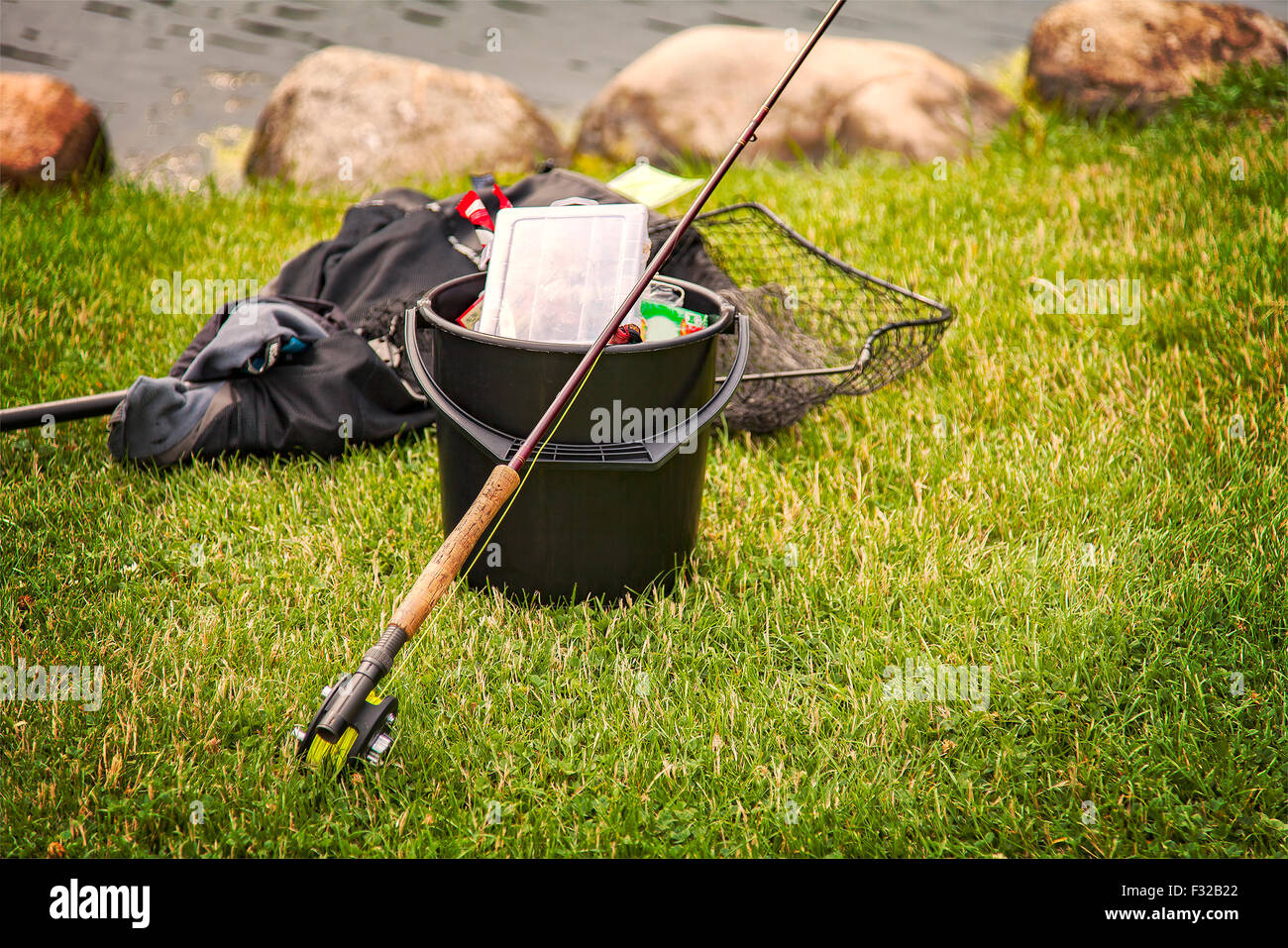 https://c8.alamy.com/comp/F32B22/image-of-fishing-gear-on-the-grassy-shore-F32B22.jpg