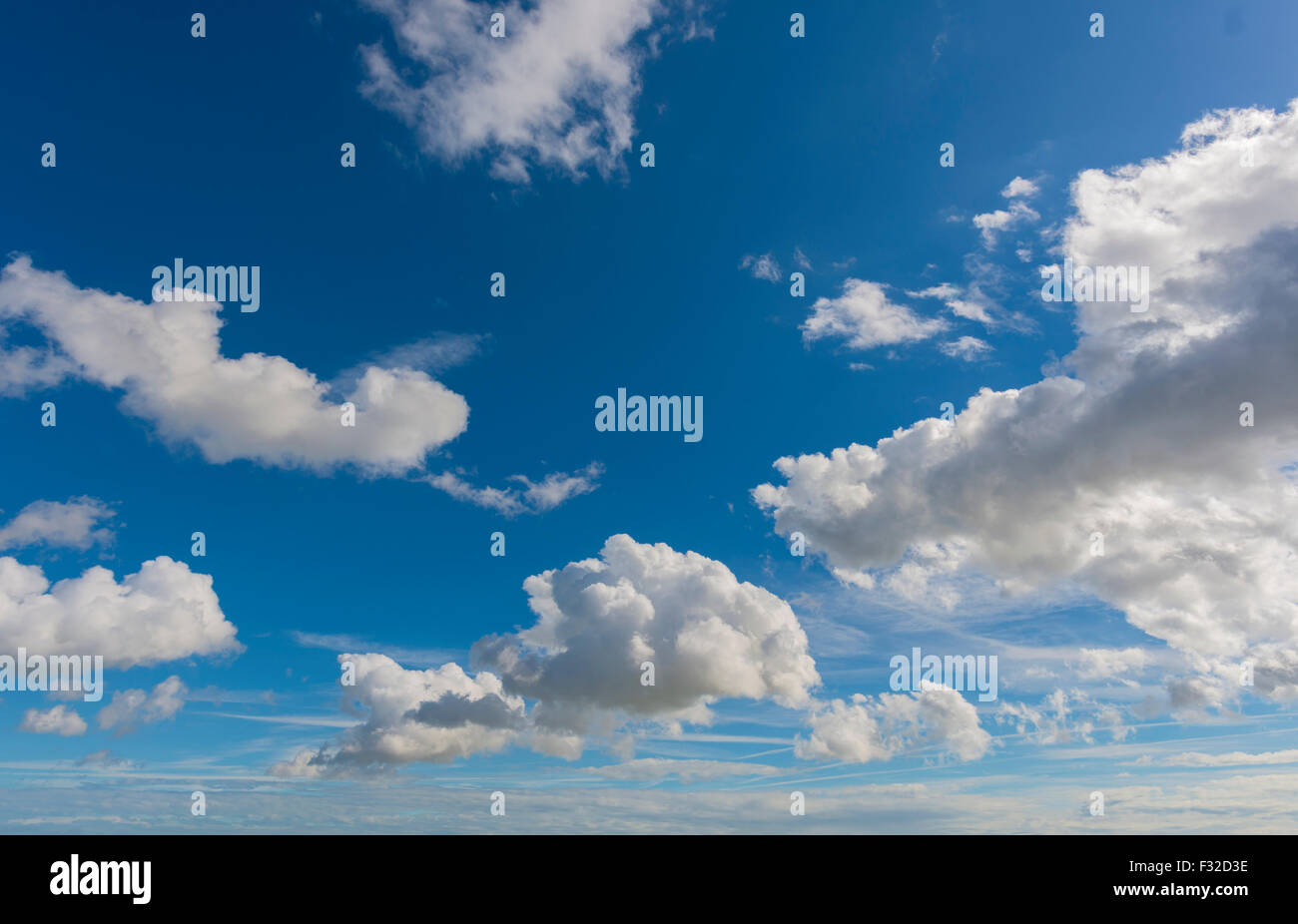 White fluffy cumulus clouds floating in a deep blue sky Stock Photo - Alamy