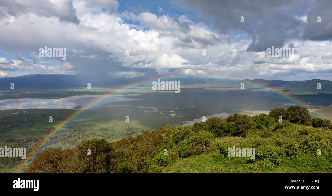 Panoramic view of rainbow at Ngorongoro Crater, Serengeti, Tanzania from Ngorongoro Wildlife Lodge on the crater's rim Stock Photo