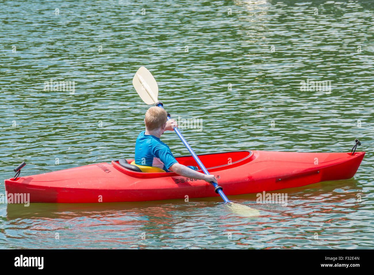 Young boy kayaking on a lake Stock Photo