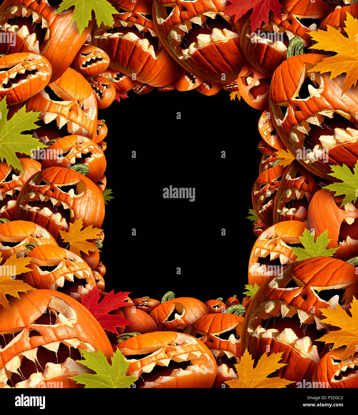 Halloween vertical border frame with empty blank copy space as a group of carved jackolantern pumpkin group and fall leaves as a concept and design element for a creepy advertisement and marketing announcement for an autumn time party. Stock Photo