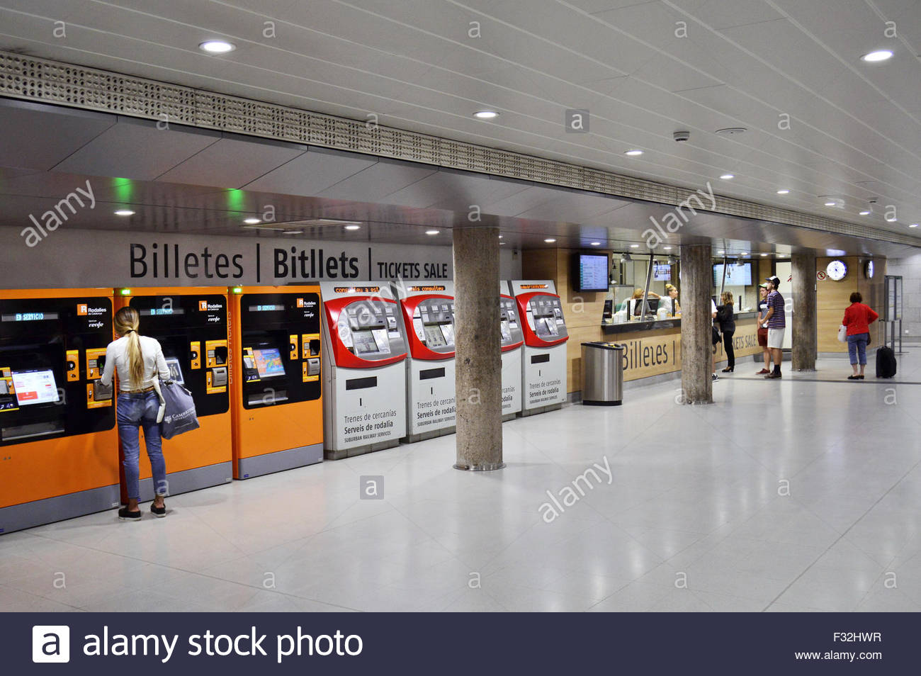 Purchasing metro tickets from automated vending machines and ticket office in Barcelona Spain Europe Stock Photo