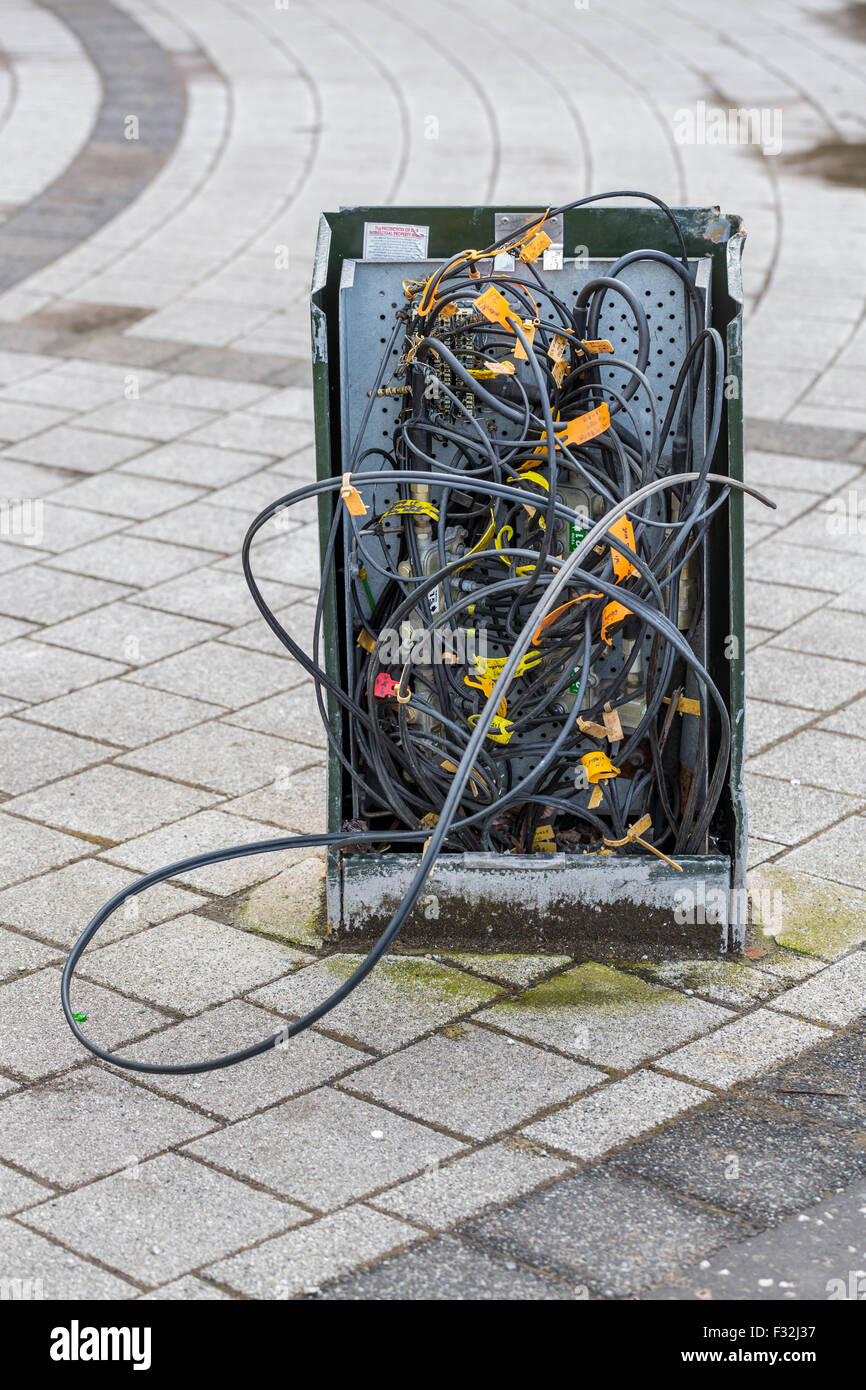 A damaged Telephone Junction box on a UK street Stock Photo