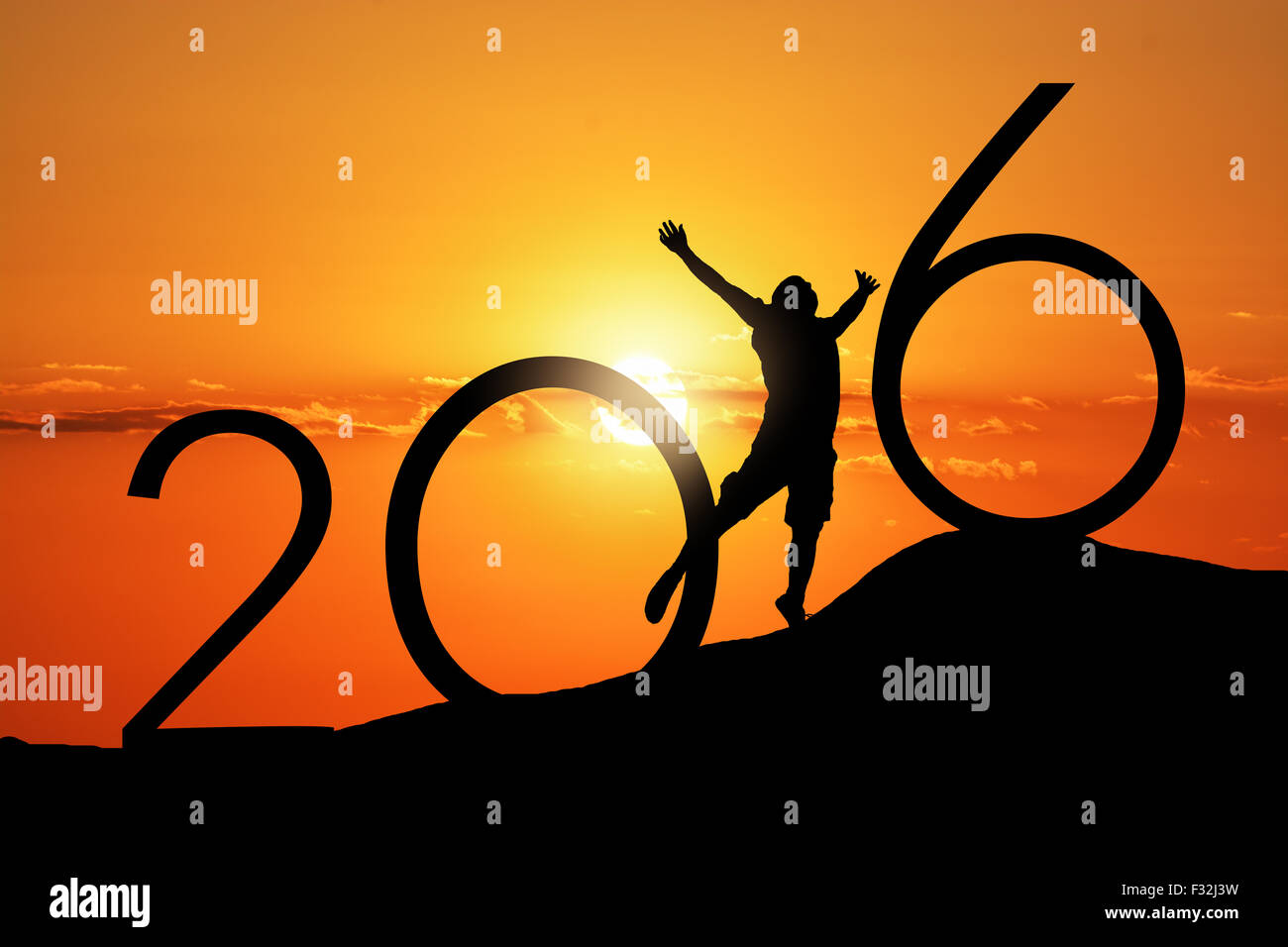Silhouette person jumping over 2015 on the hill at sunset Stock Photo
