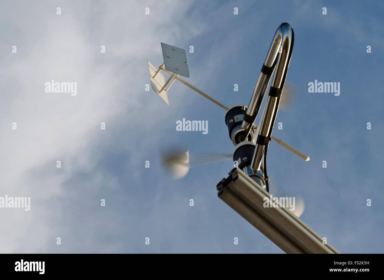 Anemometer and wind vane on blue sky Stock Photo