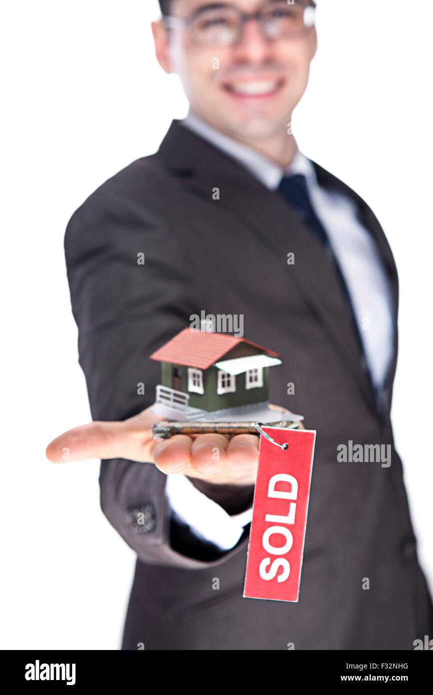 Realtor Holding Up house and Old Key with Red SOLD Sign Stock Photo - Alamy
