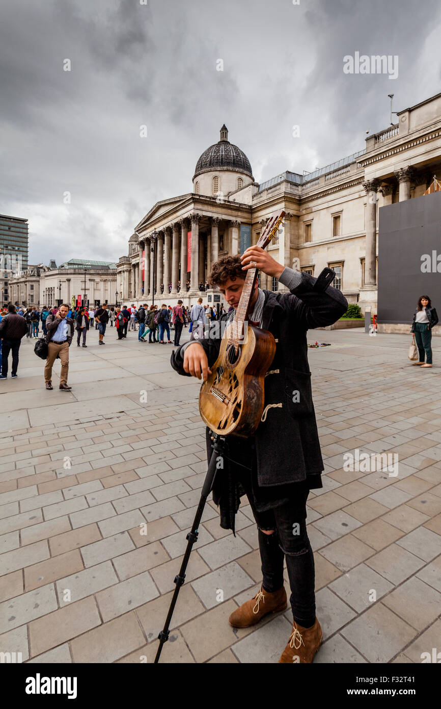 A Street Musician Plays Outside The National Gallery, Trafalgar Square, London, UK Stock Photo