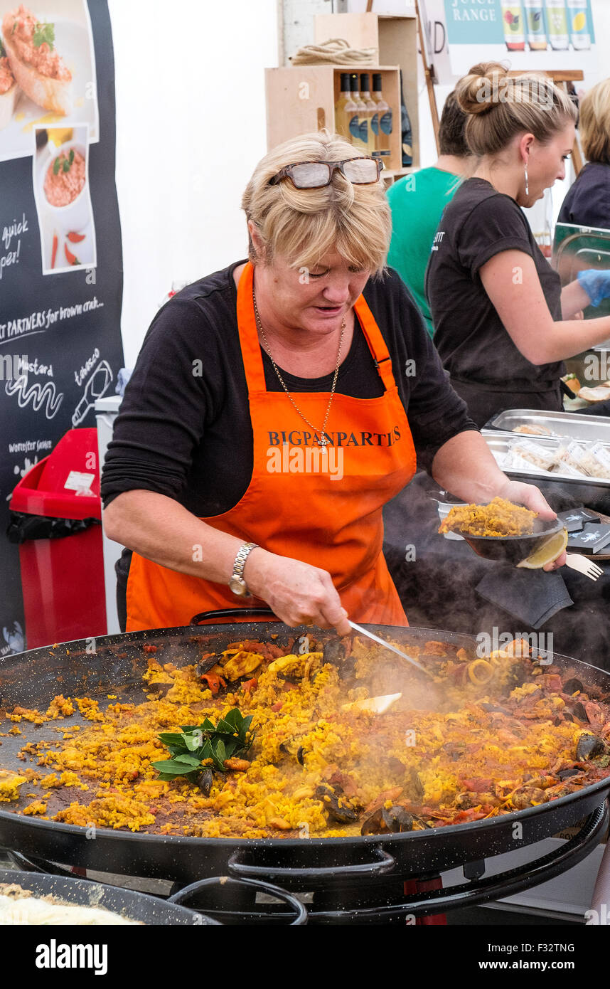 Paella being served from a huge pan at the Cornish food festival in