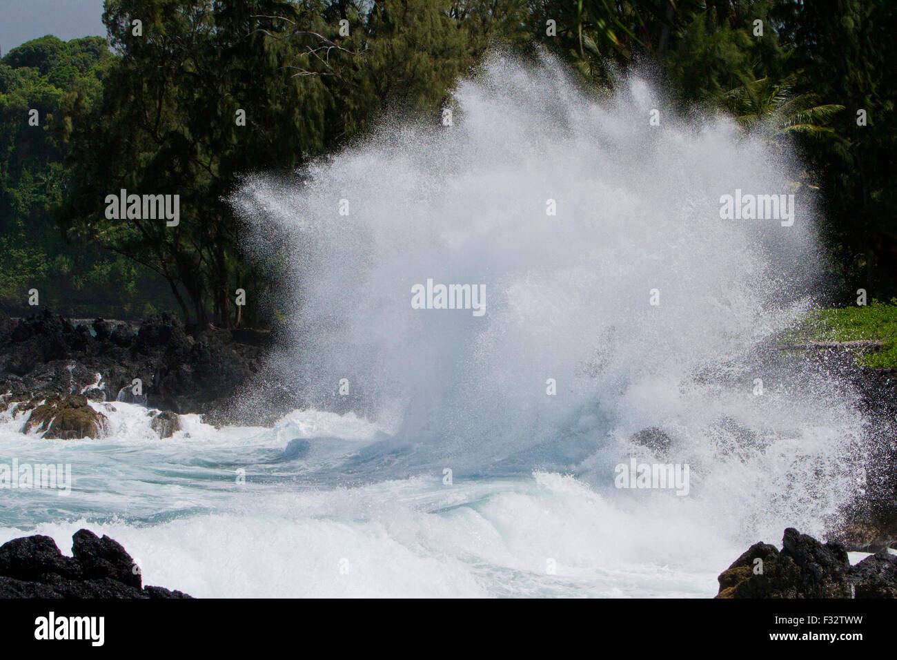 Waves crashing against rocks along the shoreline at Keanae Peninsula, just off Hana Highway, Maui, Hawaii in August Stock Photo