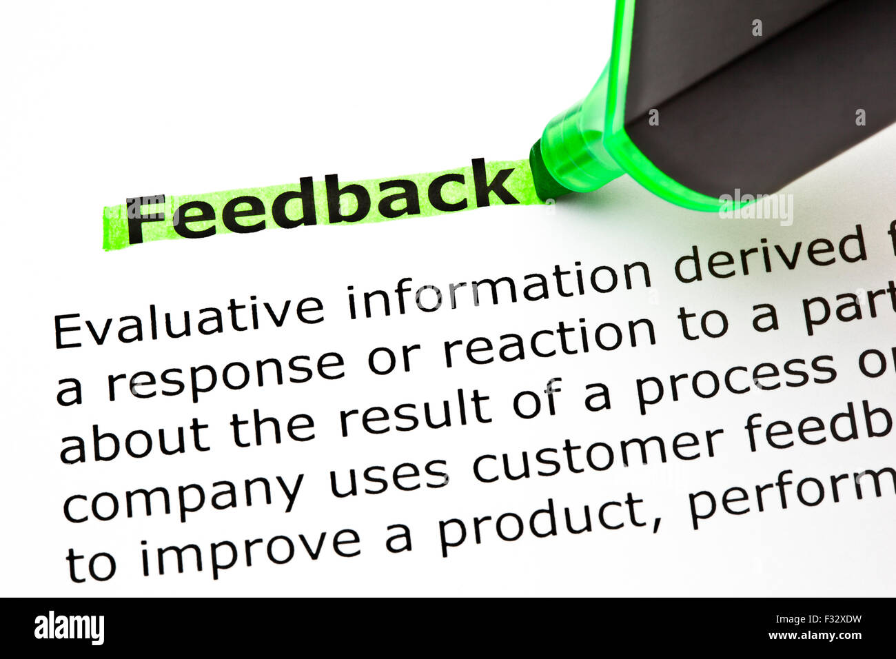 Definition of the word Feedback, highlighted with green felt tip pen. Stock Photo