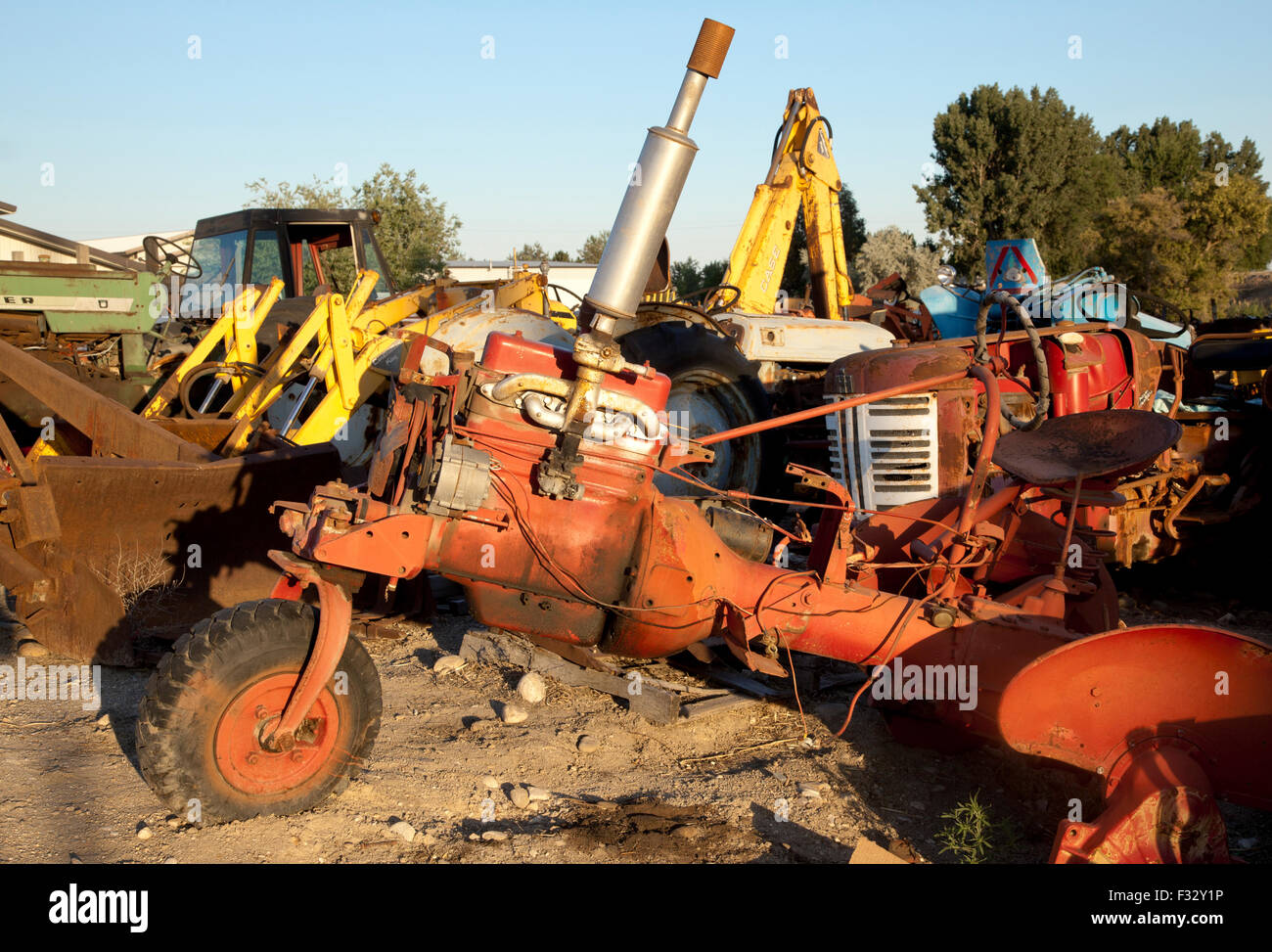 Rusted farm tractor parts in junkyard at sunset,US,2015 Stock Photo Alamy