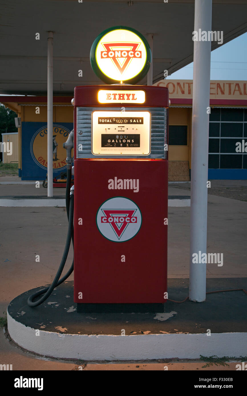 Vintage Conoco gas pump illuminated at dusk along Route 66 in Tucamcari, New Mexico. Stock Photo