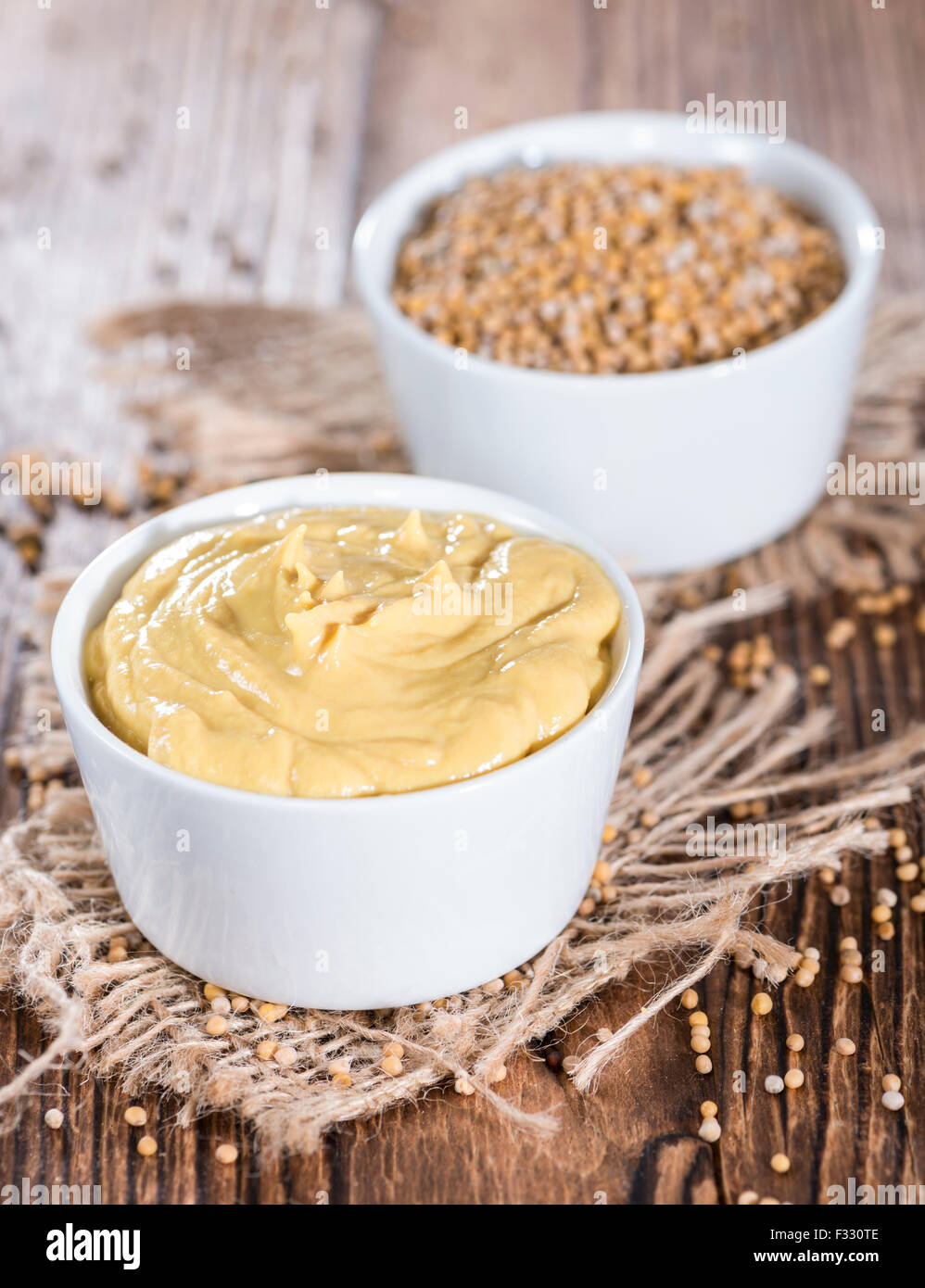 Portion of Mustard (on vintage wooden background) Stock Photo