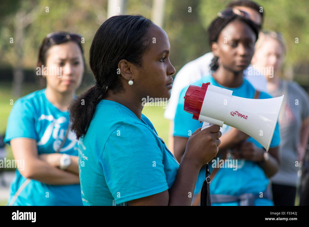 A community volunteer from a group called Tiyya an advocacy group for refugees explains the Walk for Unity. Stock Photo