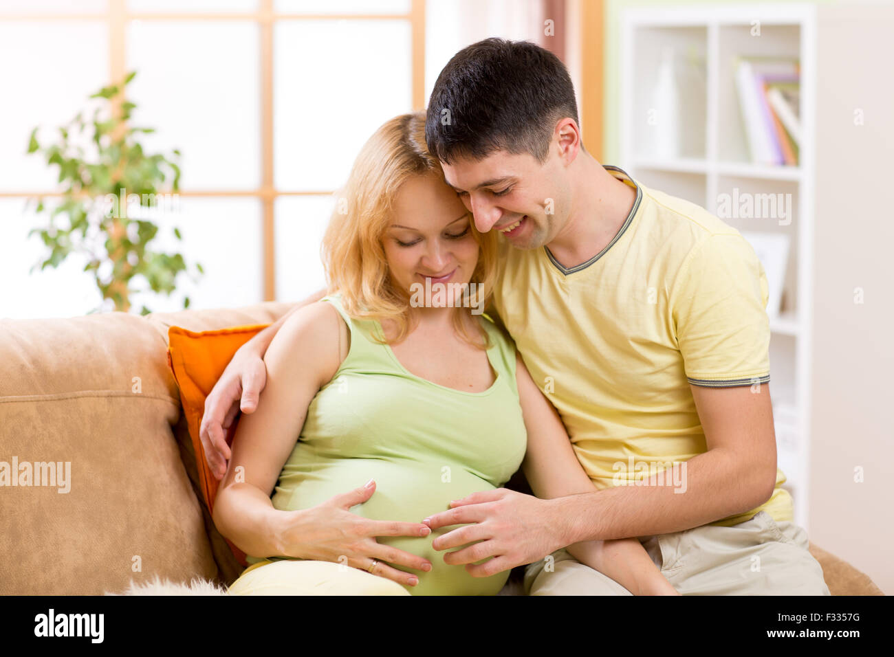 Portrait of happy couple pending baby Stock Photo