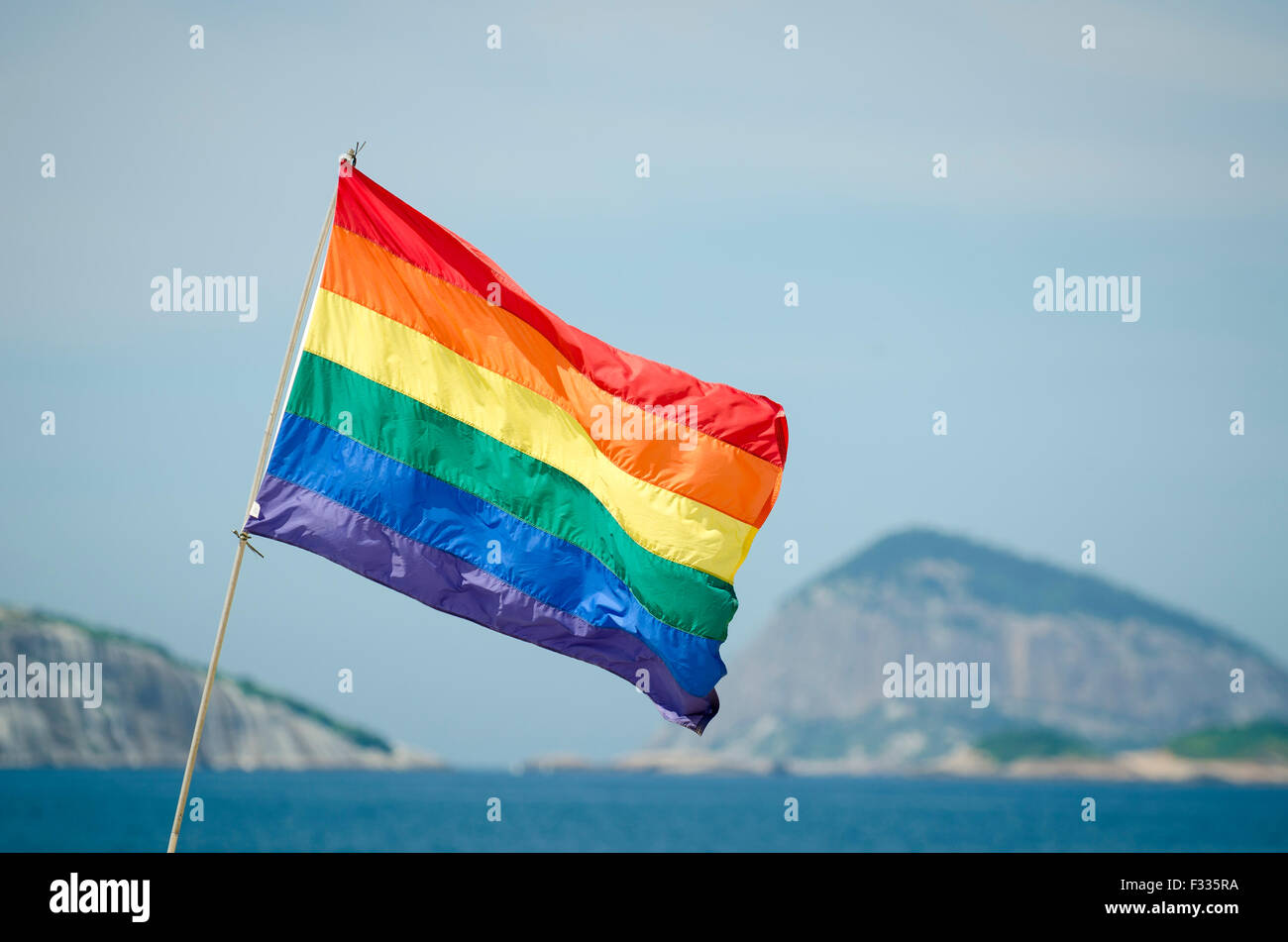 Gay pride rainbow flag flying above the Farme de Amoedo section of Ipanema Beach, in Rio de Janeiro, Brazil Stock Photo
