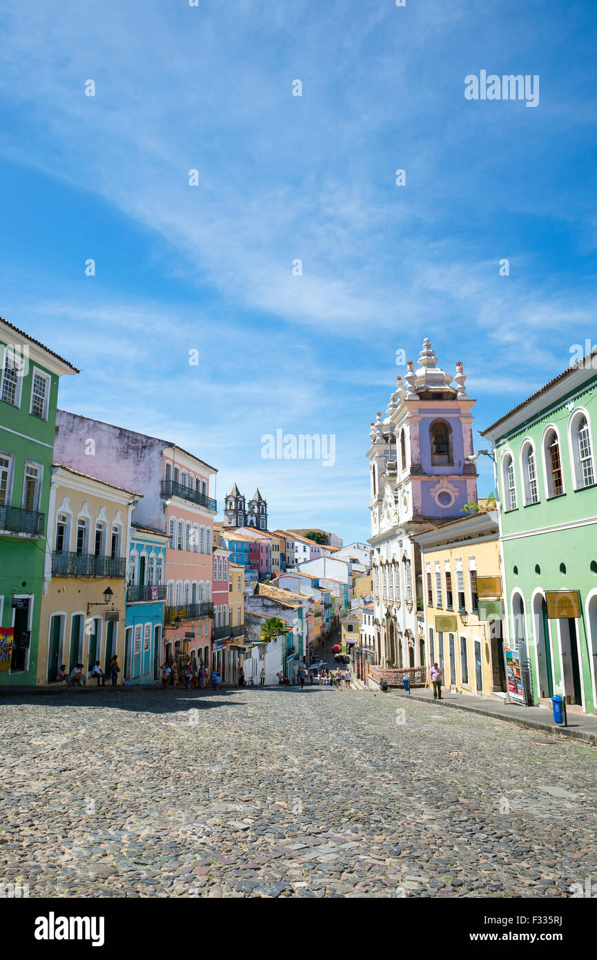 SALVADOR, BRAZIL - MARCH 12, 2015: Pedestrians walk through a plaza surrounded by colonial buildings in the historic Pelourinho. Stock Photo