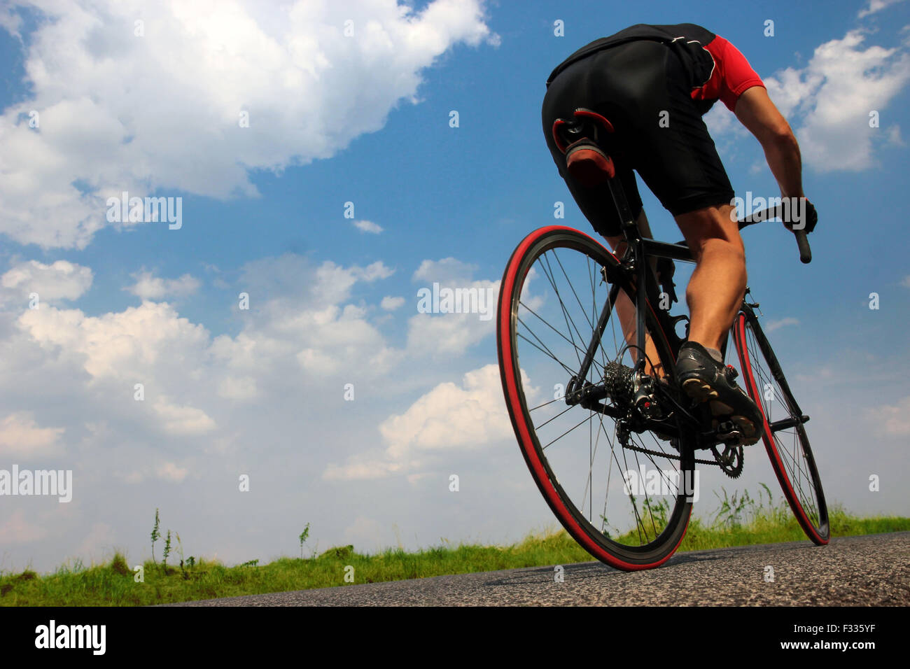 cyclist rides on asphalt road Stock Photo