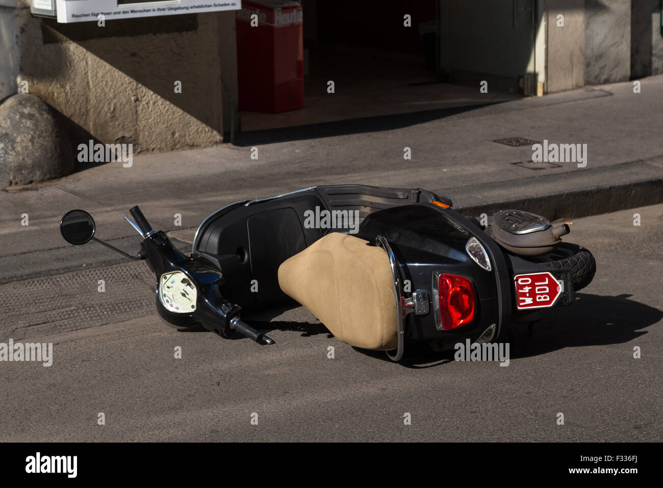 VIENNA, AUSTRIA - 8TH AUGUST 2015: A parked scooter which has been knocked over on a street in Vienna. Stock Photo
