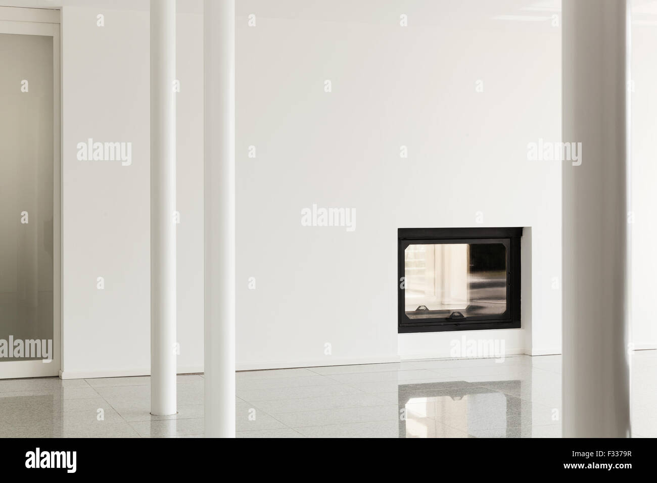 modern house, empty room with pillar and fireplace, white walls Stock Photo