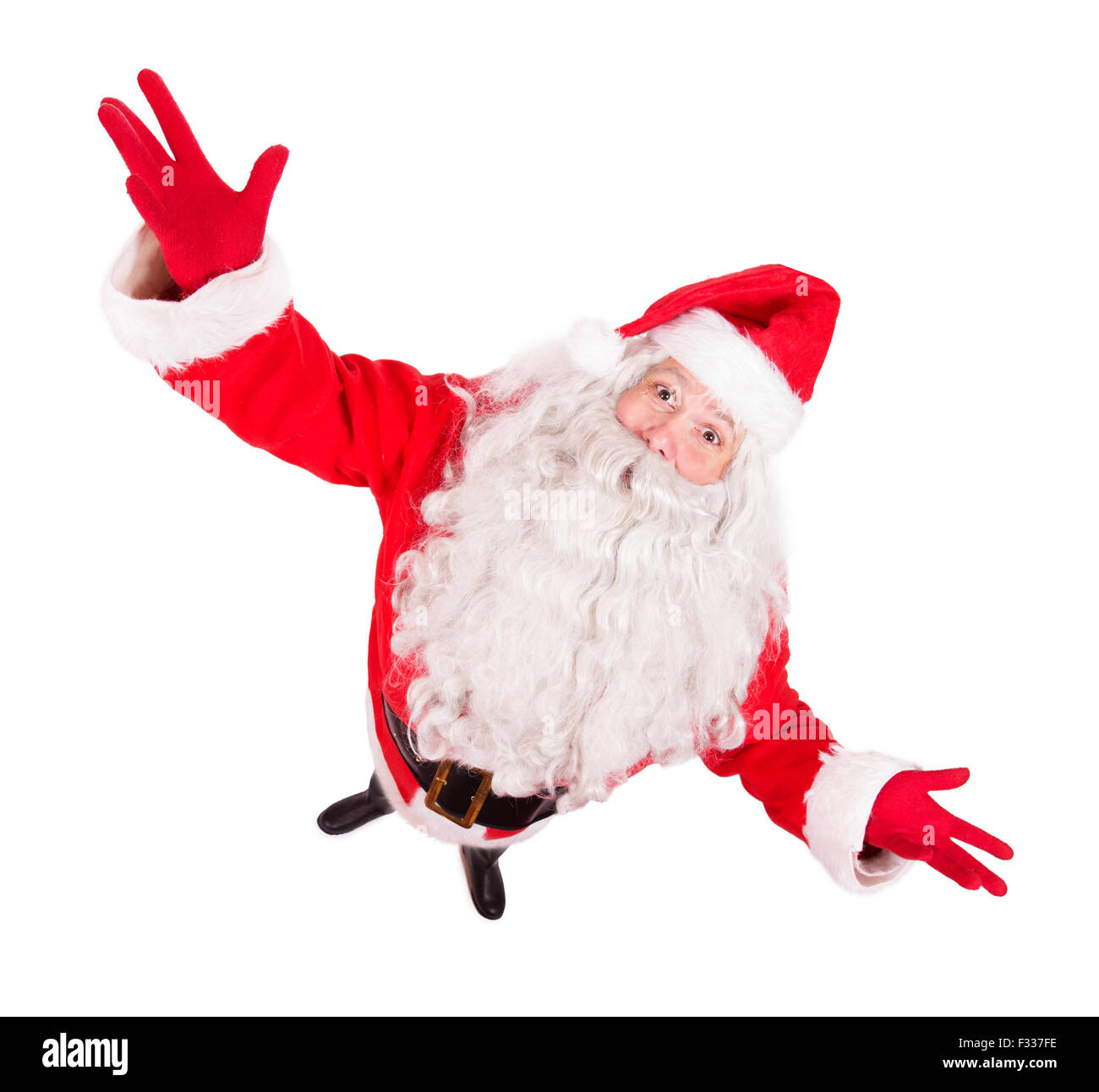 Santa Claus spread his arms wide  and looking up to camera Stock Photo