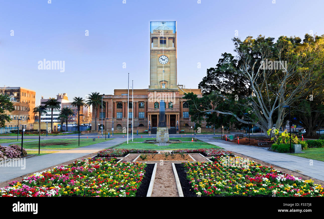 newcastle Australia hown hall facade from park with blooming flowers during reconstruction of clock tower Stock Photo