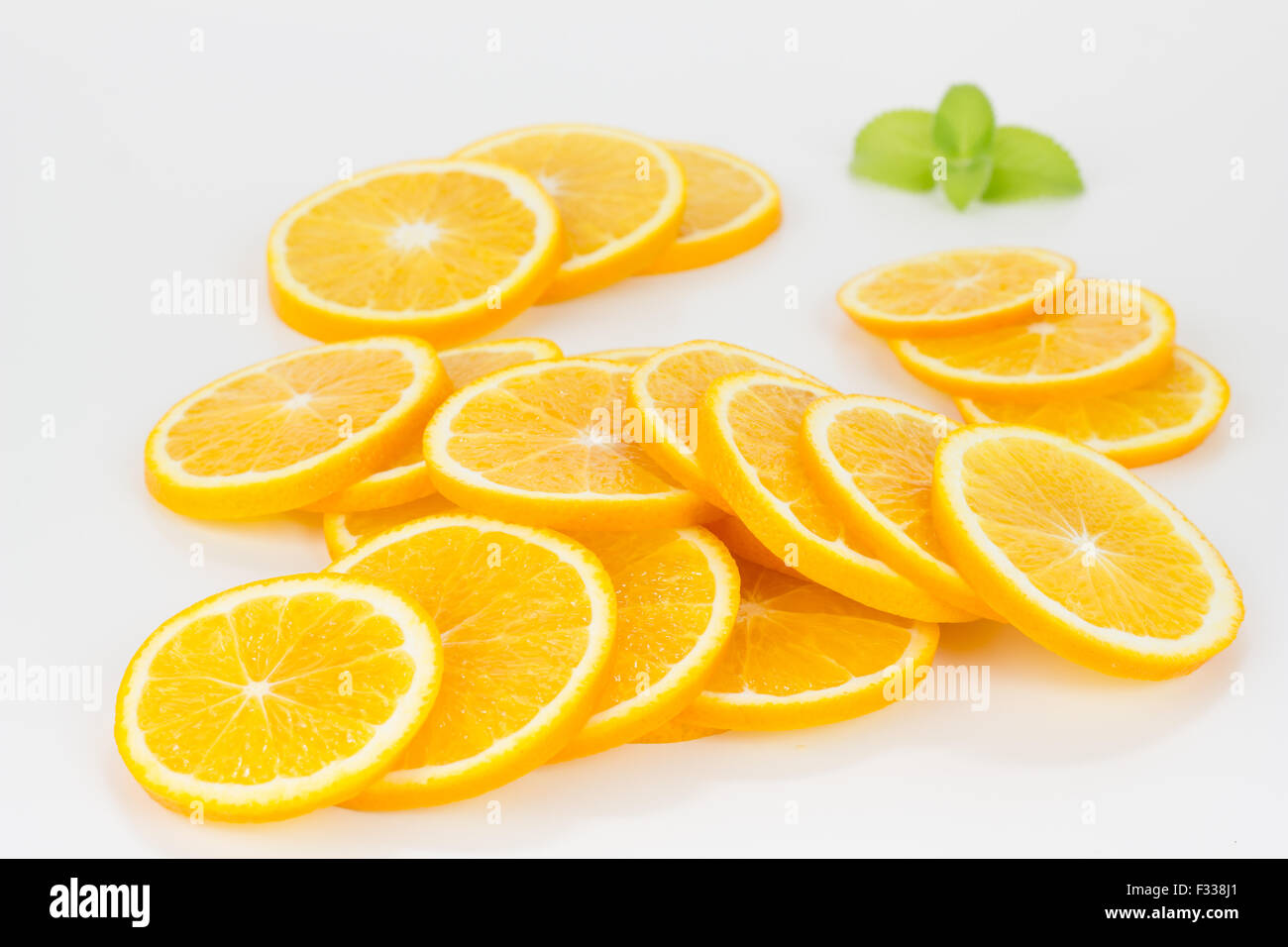 Orange slices formed in a stack, isolated on white Stock Photo - Alamy