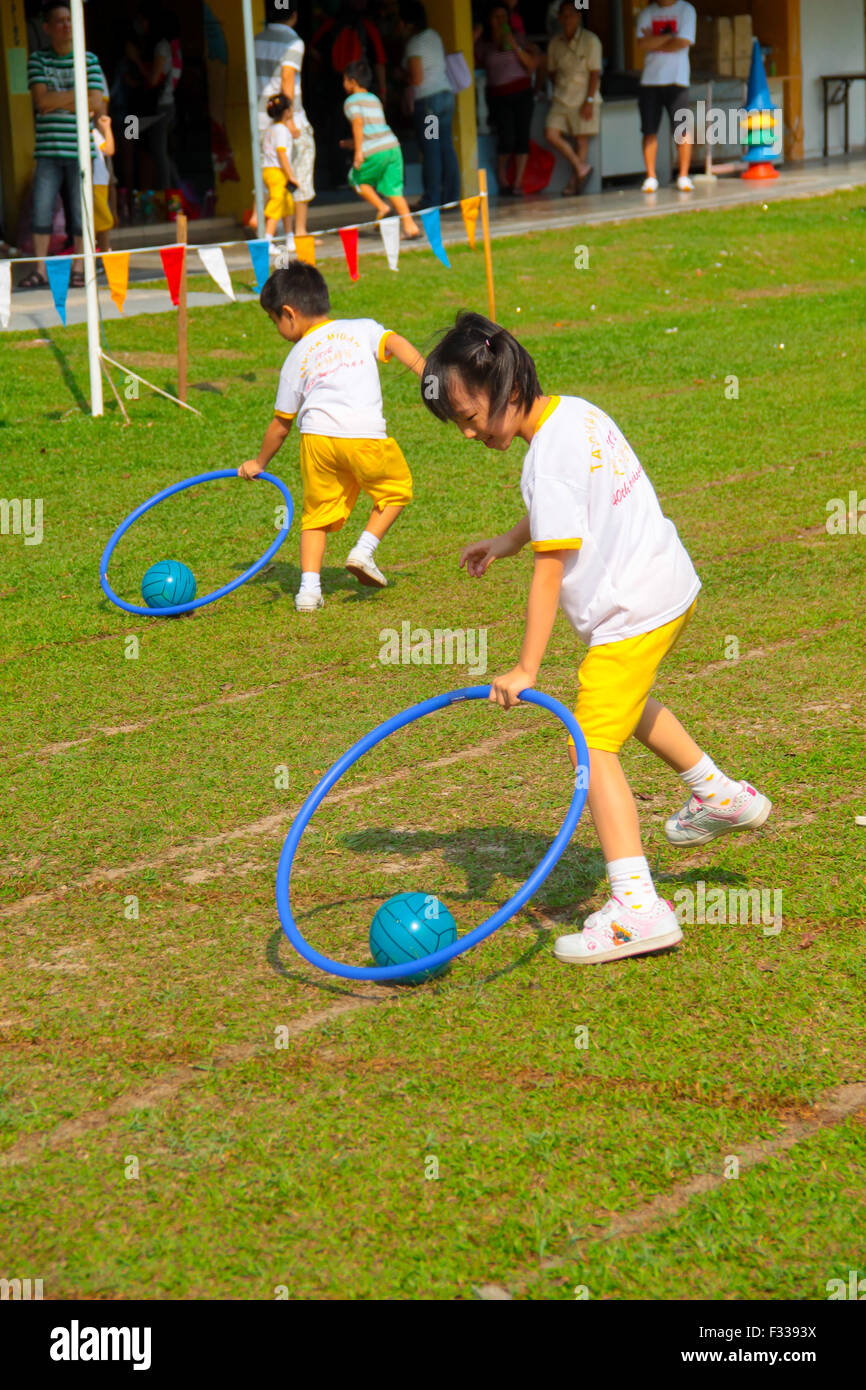 Hula hoop game children hi-res stock photography and images - Alamy