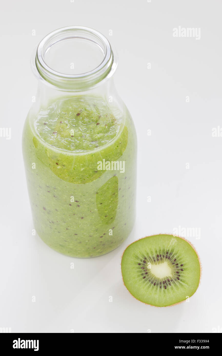 Kiwi and orange juice in glass bottles isolated on white. Stock Photo