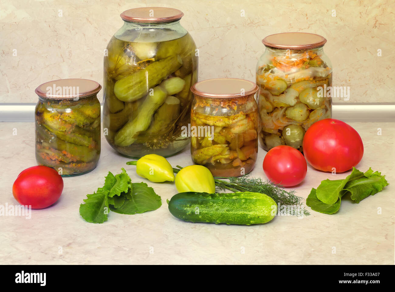 Home canning jars with canned along with carrots and spices cucumbers
