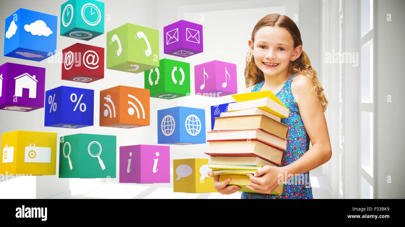 Composite image of cute little girl carrying books in library Stock Photo