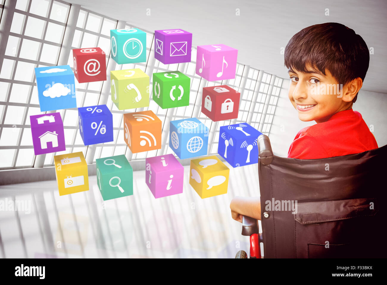 Composite image of boy sitting in wheelchair in school Stock Photo