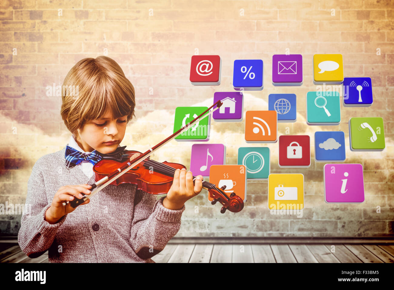 Composite image of cute little boy playing violin Stock Photo