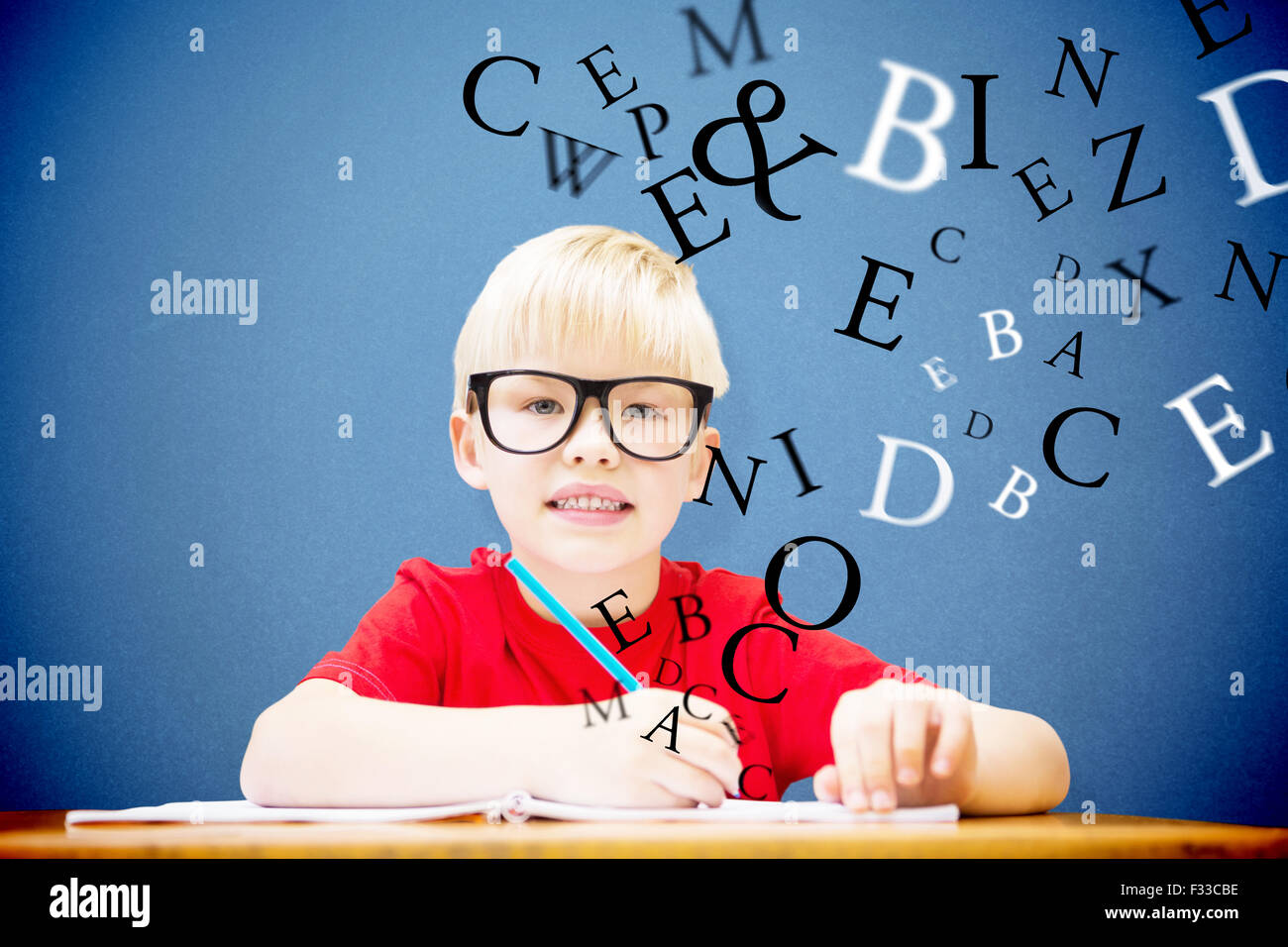 Composite image of cute pupil at desk Stock Photo - Alamy