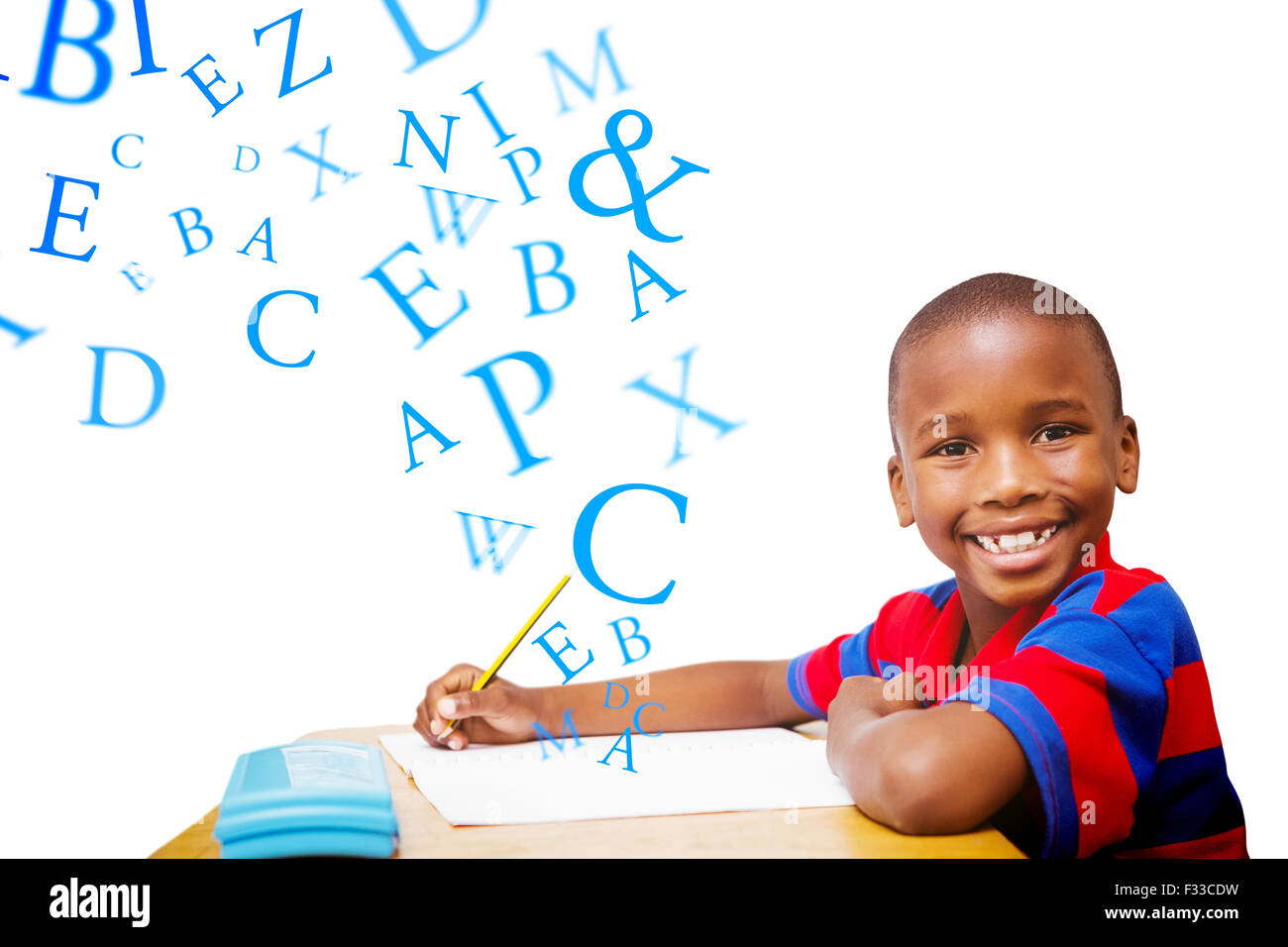 Composite image of happy pupil at desk Stock Photo - Alamy