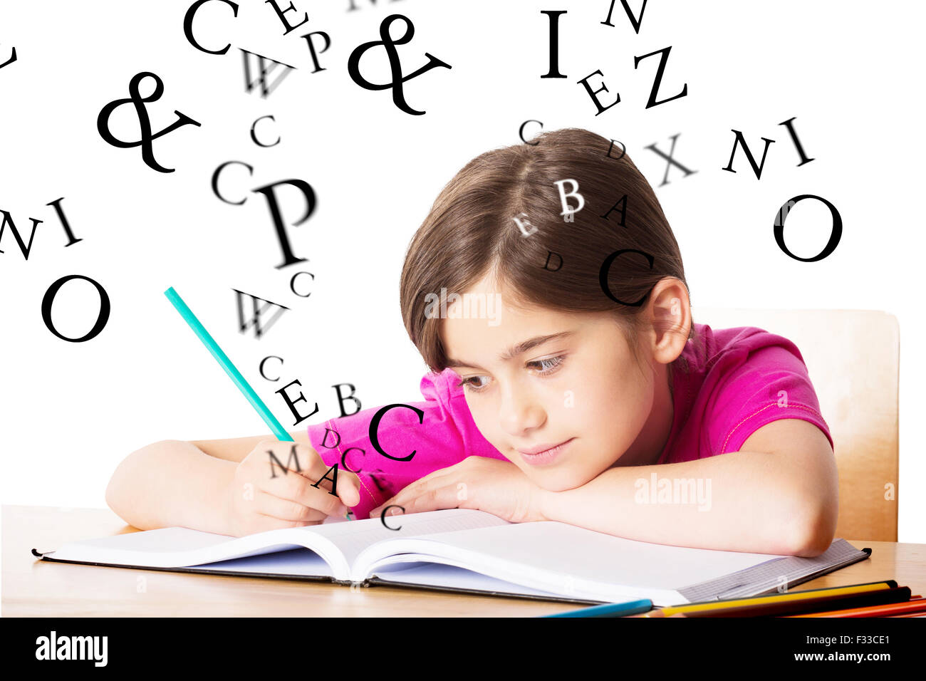 Composite image of cute pupil working at her desk Stock Photo - Alamy