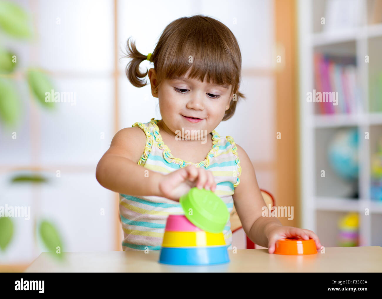 little child girl playing with educational toys Stock Photo - Alamy