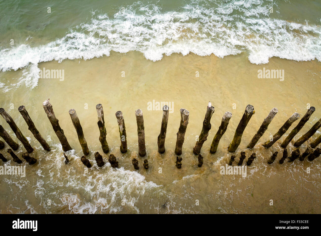 Barrier of wooden posts on a beach, Saint Malo, France, Europe Stock Photo