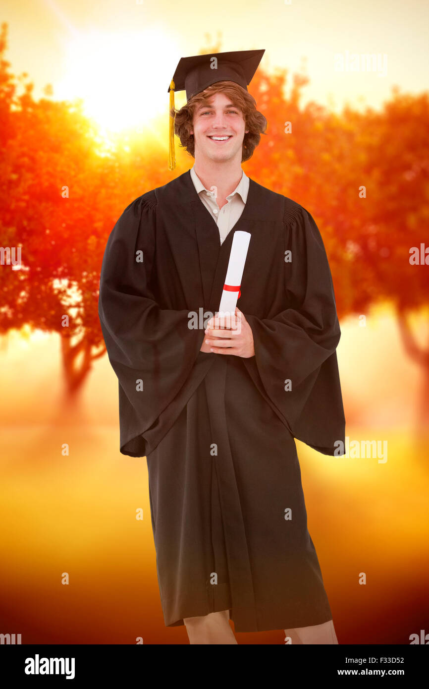 Composite image of smiling student in graduate robe Stock Photo