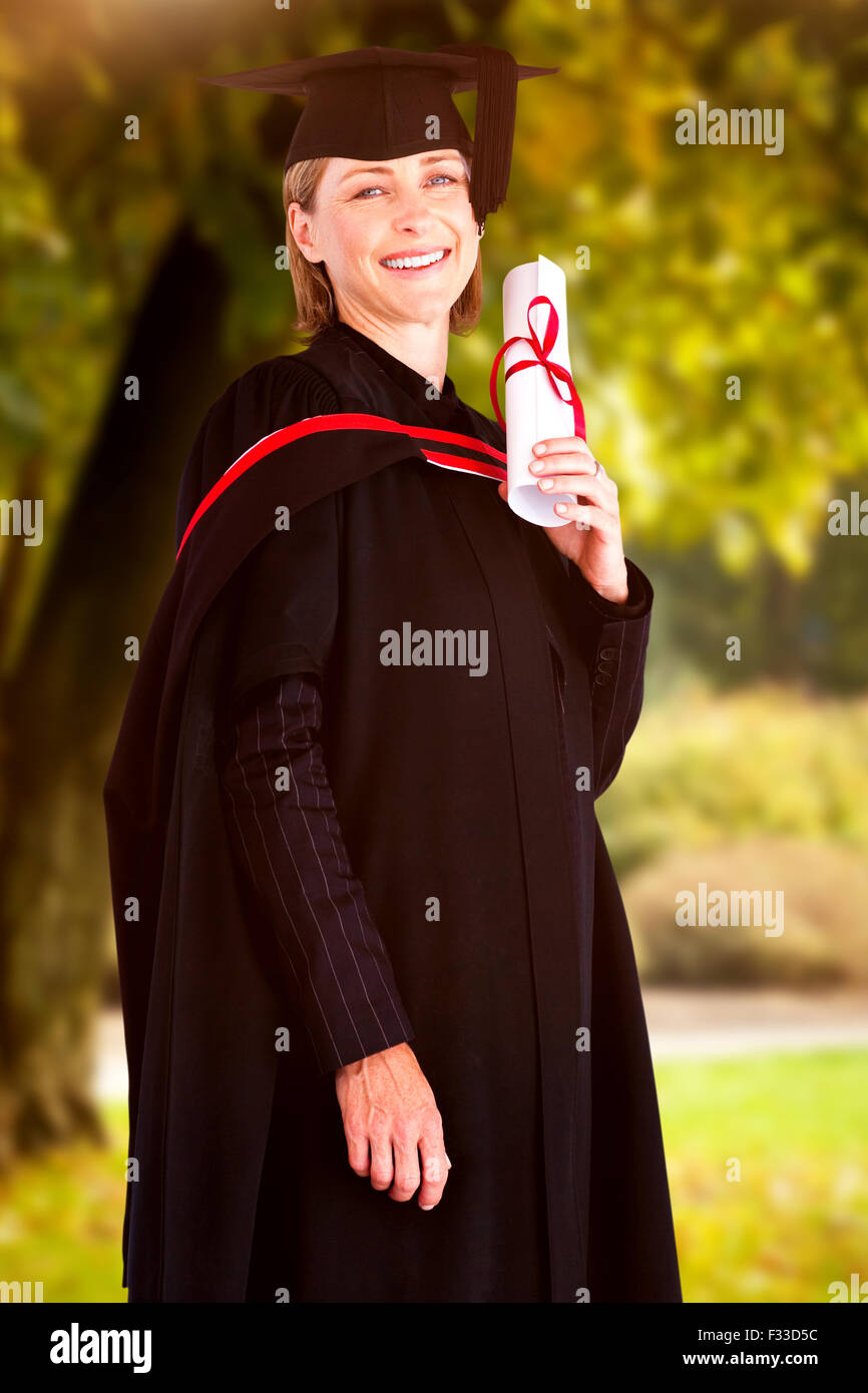 Composite image of confident graduated woman looking at the camera Stock Photo