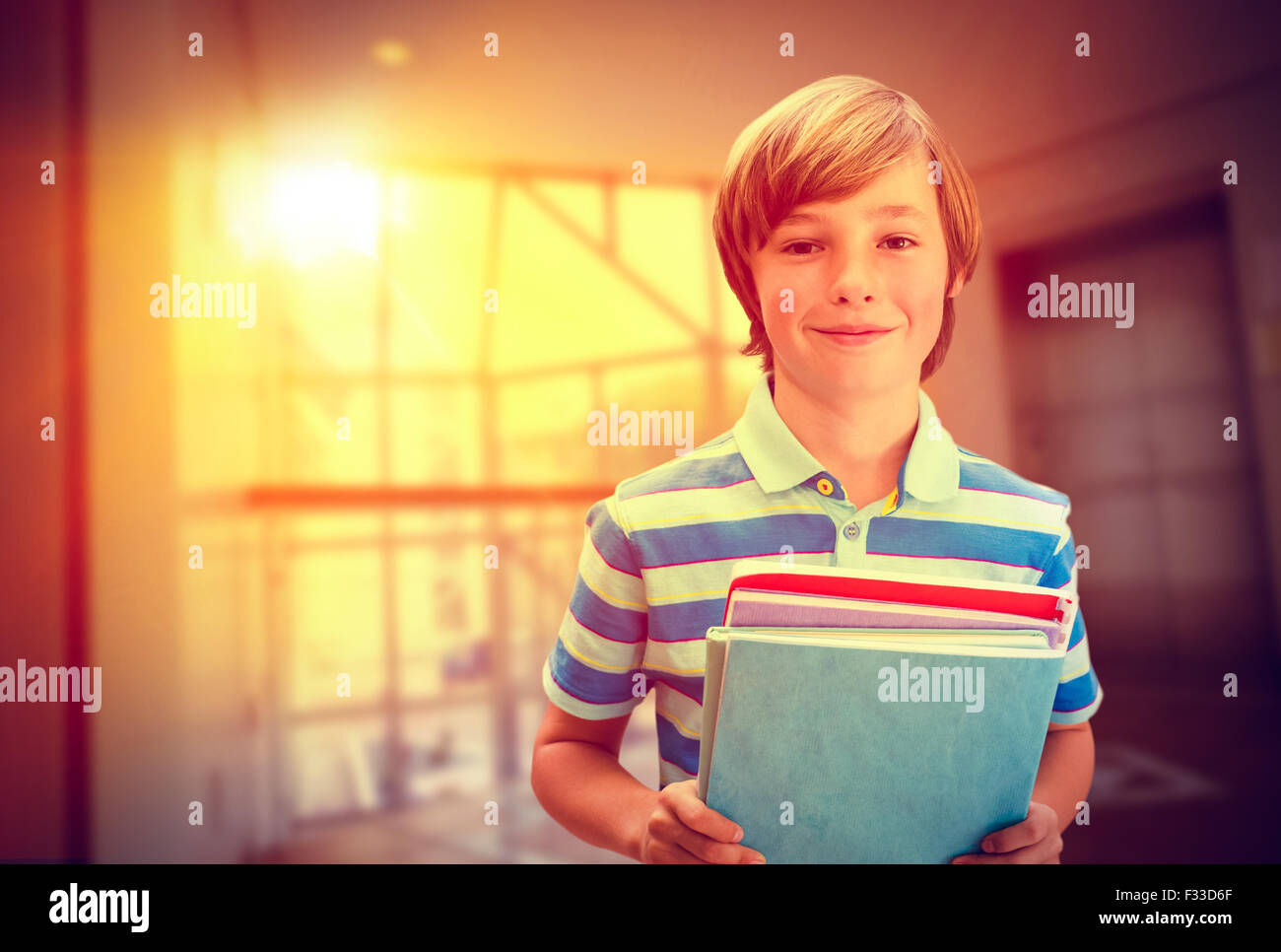 Composite image of cute pupil smiling at camera in library Stock Photo ...