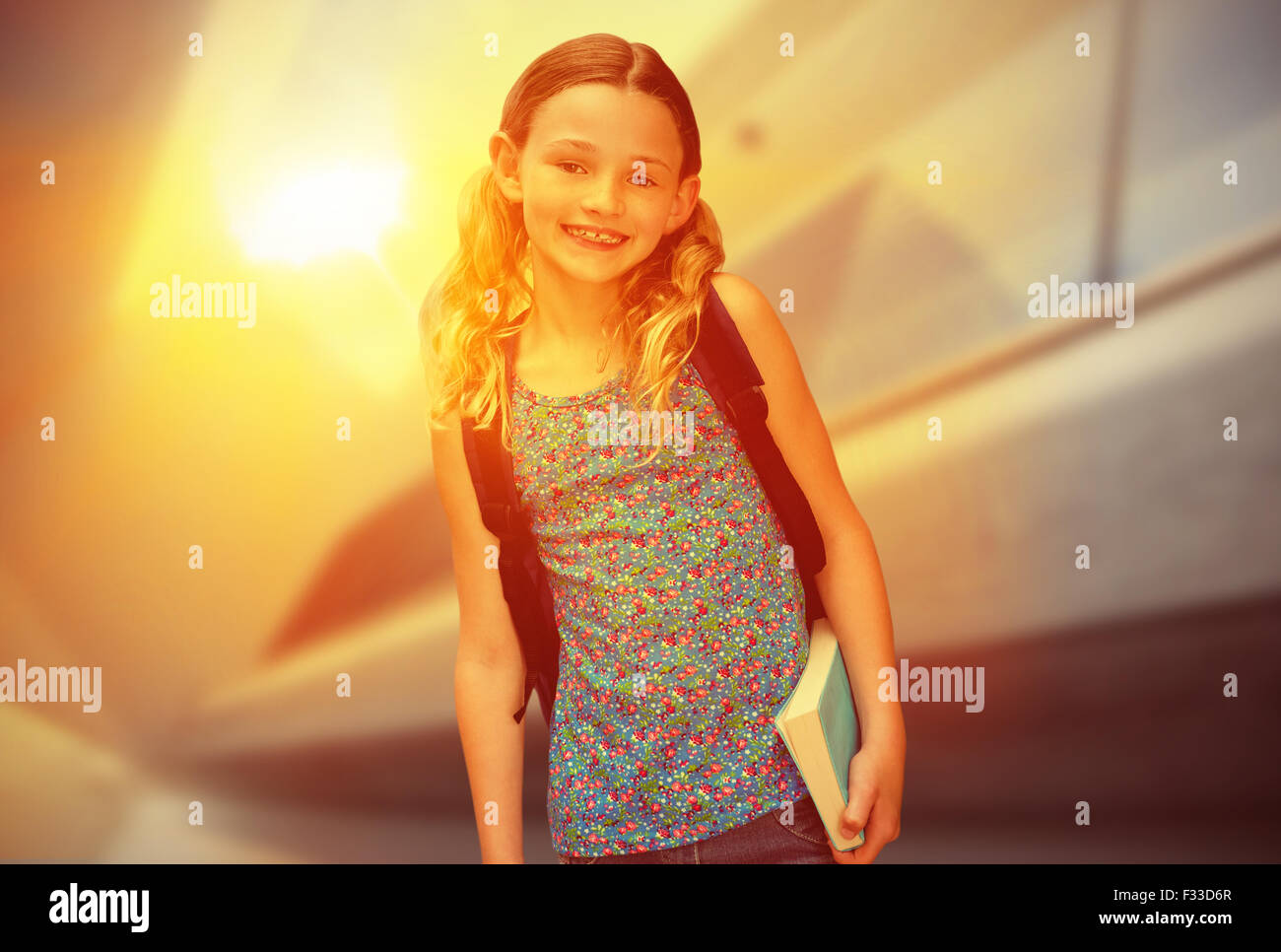 Composite image of cute little girl holding book in library Stock Photo ...