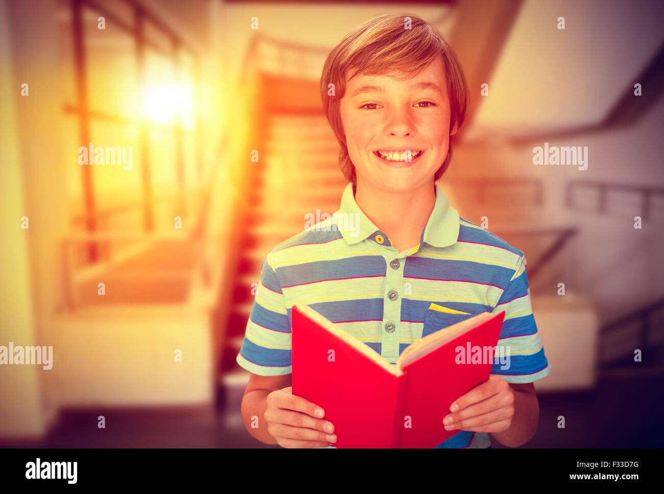 Composite image of cute pupil smiling at camera in library Stock Photo ...