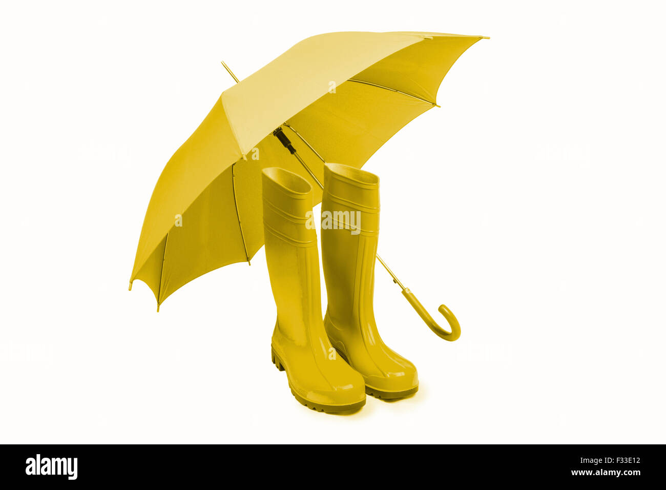 Rubber boots and umbrella isolated in yellow Stock Photo