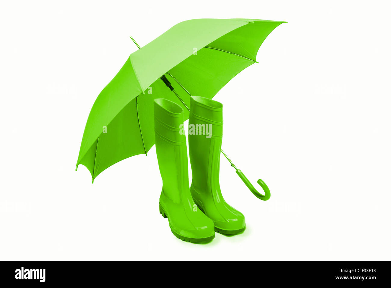 Rubber boots and umbreall isolated in green Stock Photo